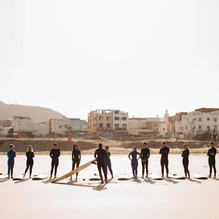 Jamal running a morning surf class on the beach at Taghazout Bay